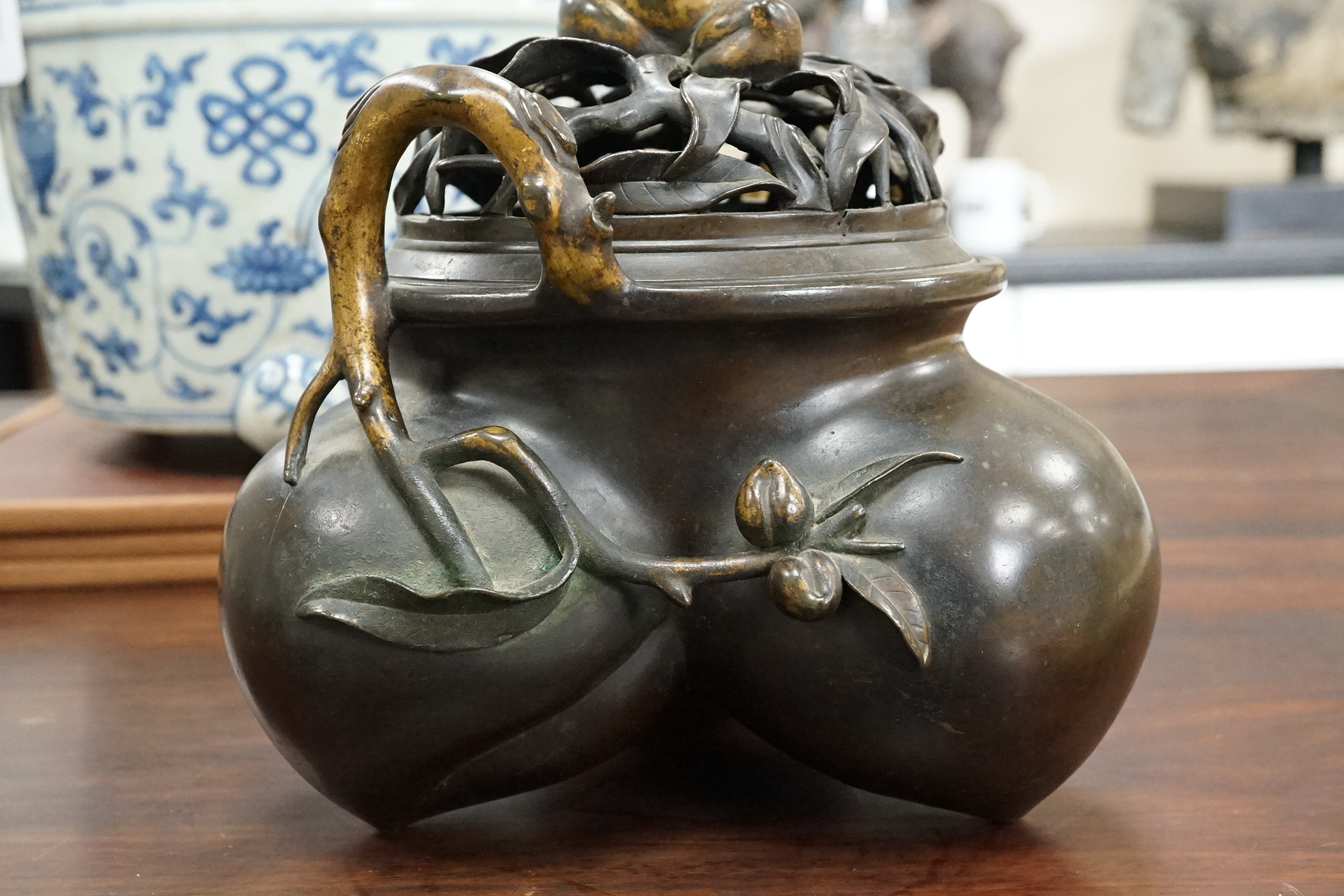 A large Chinese bronze and parcel gilt ‘peach’ censer and cover, Li, 17th/18th century